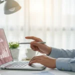 A professional researching fintech business content creation targeted keywords 2025 on a modern laptop.
